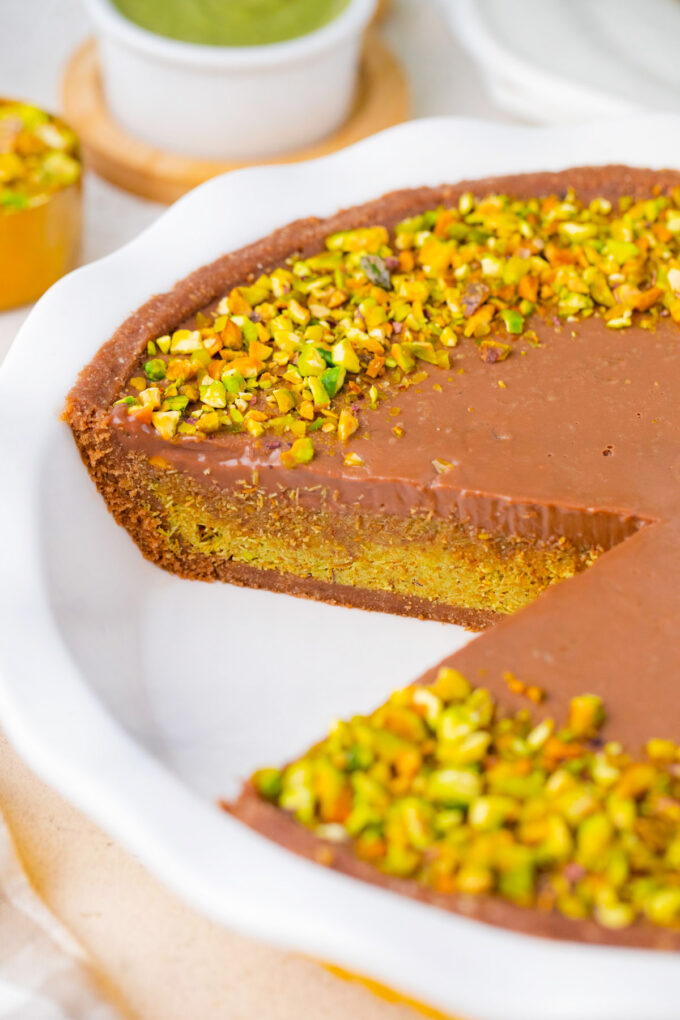 No-bake Dubai chocolate tart with layers of chocolate graham cracker crust, pistachio kataif filling, and chocolate ganache.