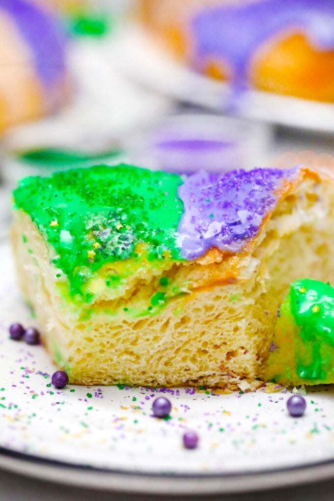 Close shot of a fluffy and tender slice of Mardi Gras King cake.