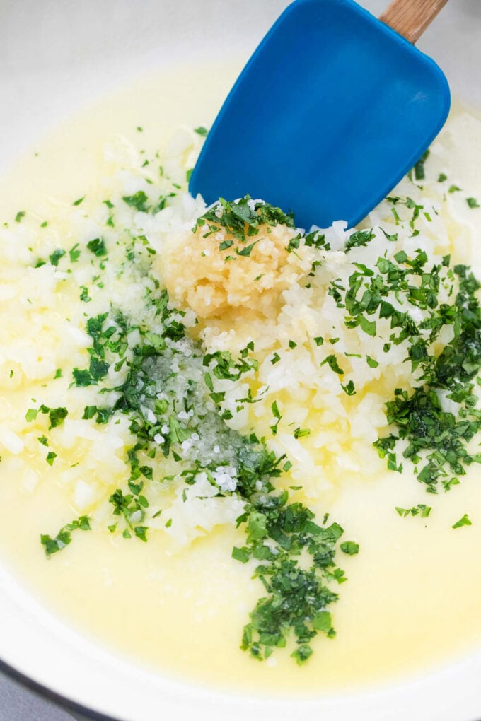 Cooking garlic and parsley in melted butter.