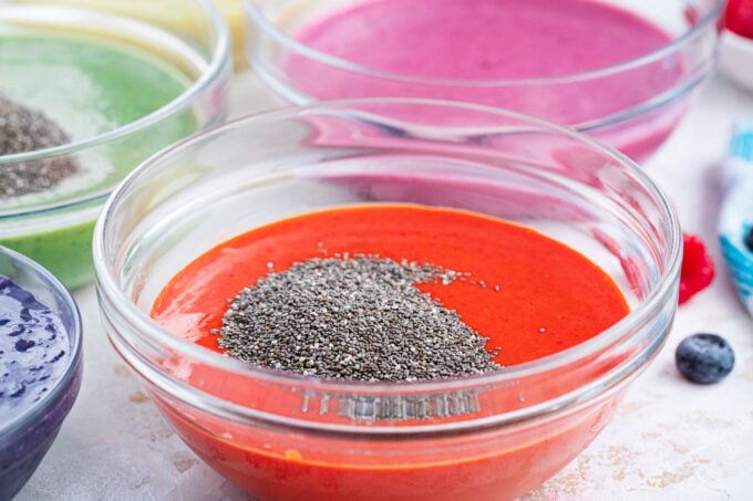 Adding chia pudding to fruit purees mixture.