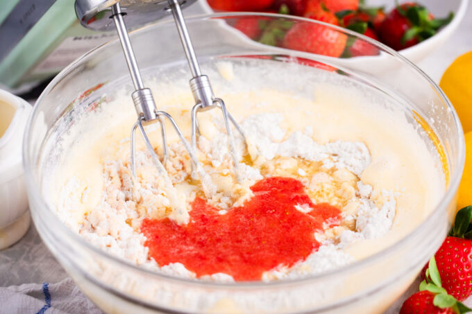Whisking strawberry madeleine batter.