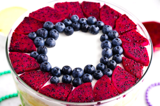 Mardi Gras trifle topped with blueberries and pink dragon fruit.