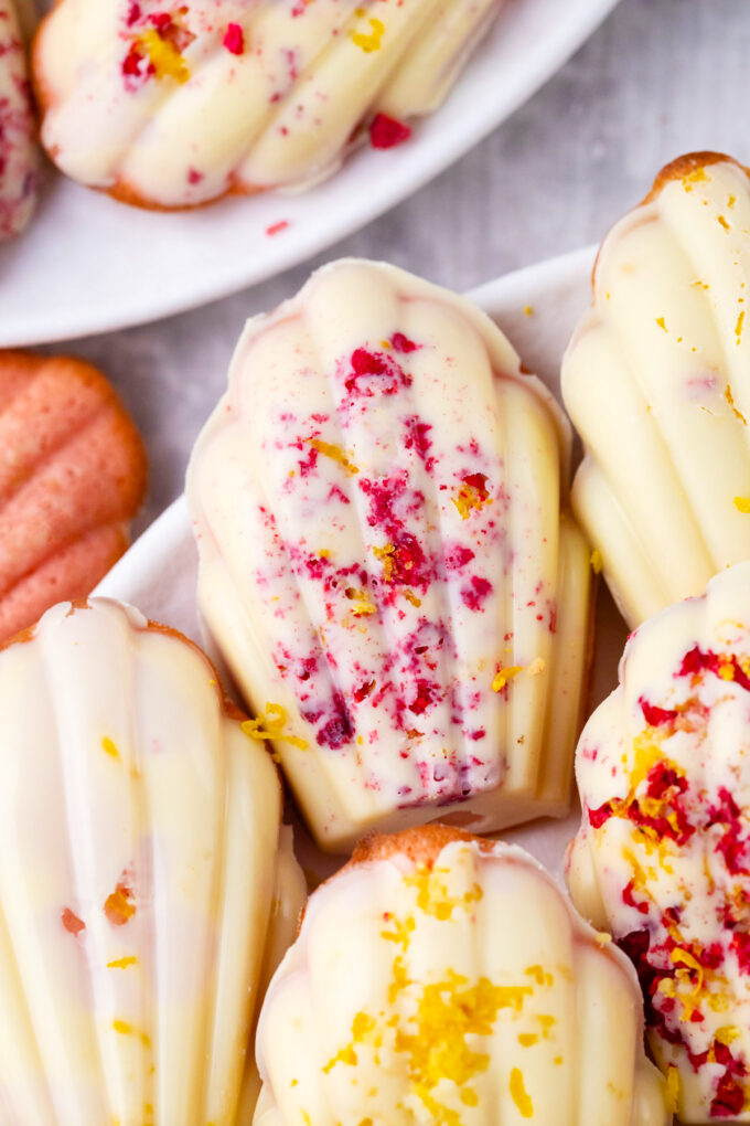 Strawberry madeleines coated in white chocolate.