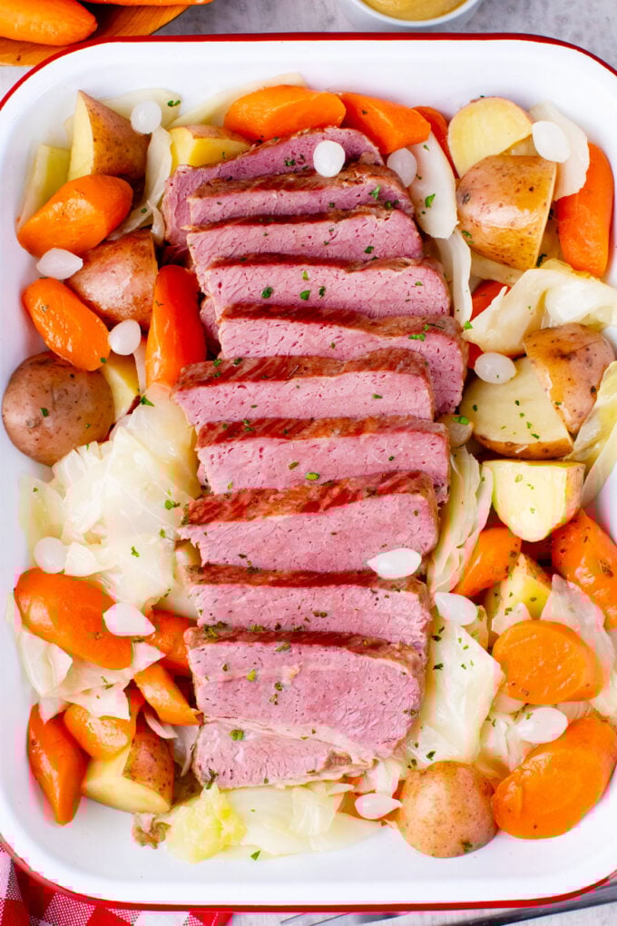 Overhead shot of tender corned beef served with veggies.