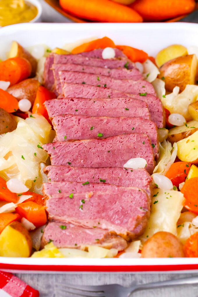 Overhead shot of tender corned beef served with carrots, cabbage, and potatoes.