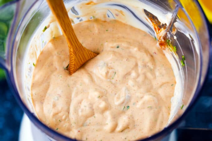 Stirring creamy chipotle sauce in a blender.