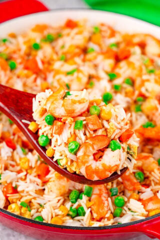A serving spoon of homemade, fluffy shrimp fried rice.