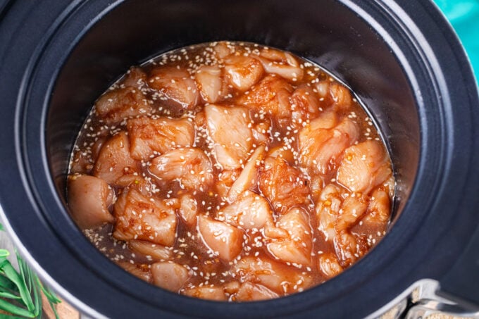 Cooking slow cooker sesame chicken.