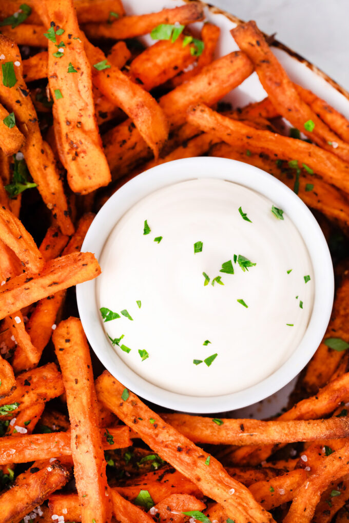 Air fried sweet potato fries with white dipping sauce.
