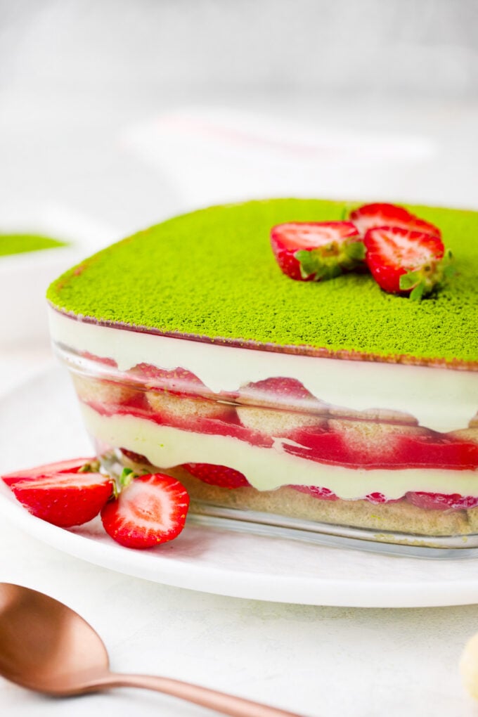 Matcha strawberry tiramisu in a glass container.