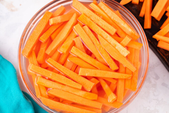 Soaking sweet potato fries.