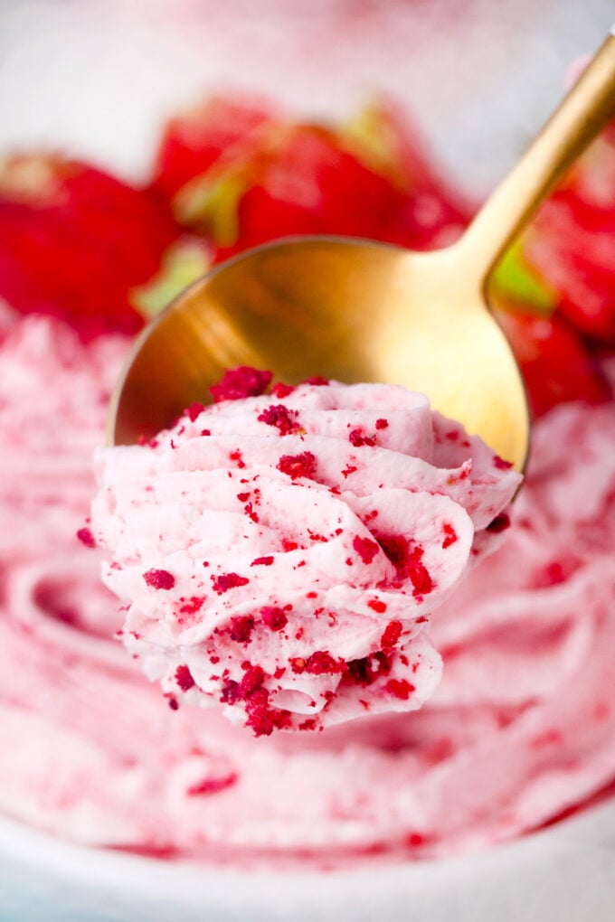 A spoonful of strawberry whipped cream.