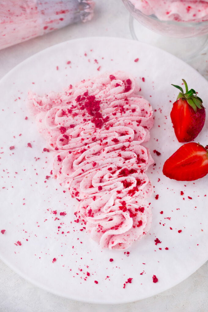 Homemade strawberry whipped cream on a plate.