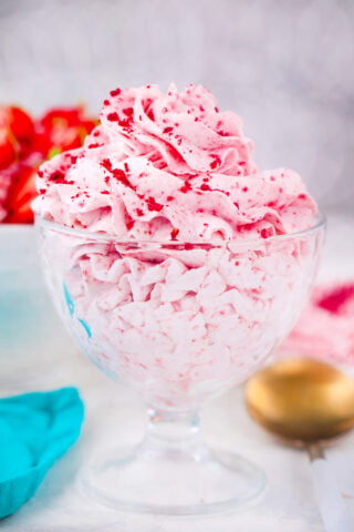 A cup with strawberry whipped cream.